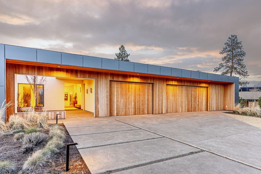 See what happens when modern architecture, refined materials, and the Bend lifestyle come together. For those who live boldly, think differently, and gravitate toward the exceptional, this single-level, architect-designed estate, is a masterclass in light, flow, and intention. Surrounded by native landscape, the 4,265 sq. ft. home features five ensuites, an office, and a layout that brings the outside in at every turn. Thoughtfully layered materials, matte aluminum, soft stucco, and warm wood, bring quiet sophistication to the bold architectural form. Oversized windows and intentional sightlines frame light, landscape, and sky, while smart systems and energy-efficient design ensure effortless modern living. At the heart of the home: two interior courtyards, one that leads to the rooftop deck and offers panoramic views of Mt. Bachelor and the stars beyond. Being sold furnished, the main living spaces complete with bedrooms, bonus, and office await your style and vision.