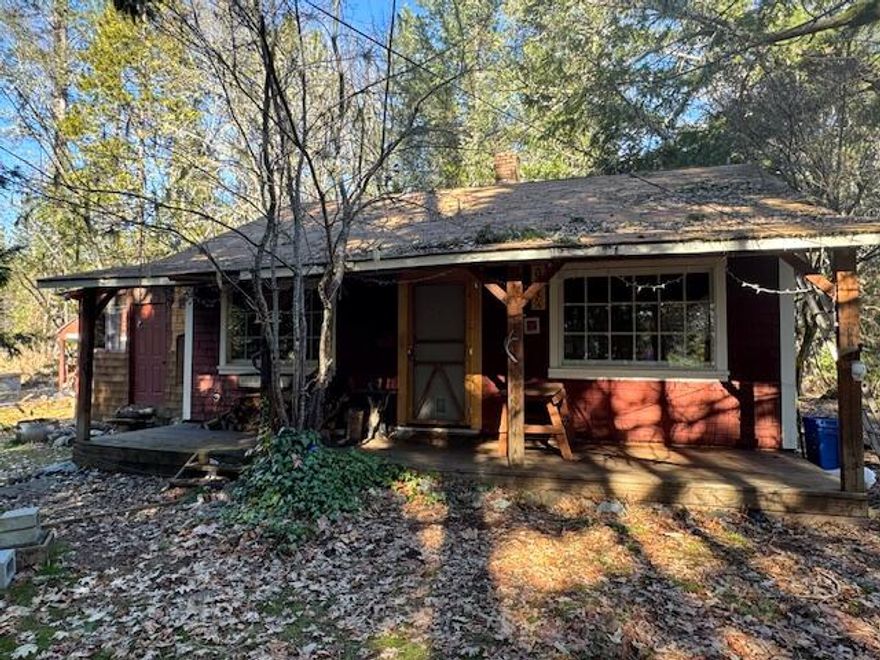 Cozy forest cabin set off the road on 1.69 acres.  In need of TLC. Property is zoned Rural Commercial (RC), and could be a great location for not only a home but maybe a 'What Not' shop as well on this frequently travelled highway to the Oregon Caves. Garage/shop with carport, RV site. Sold as-is, cash only. Inspection reports for well, septic, and home, on file.
