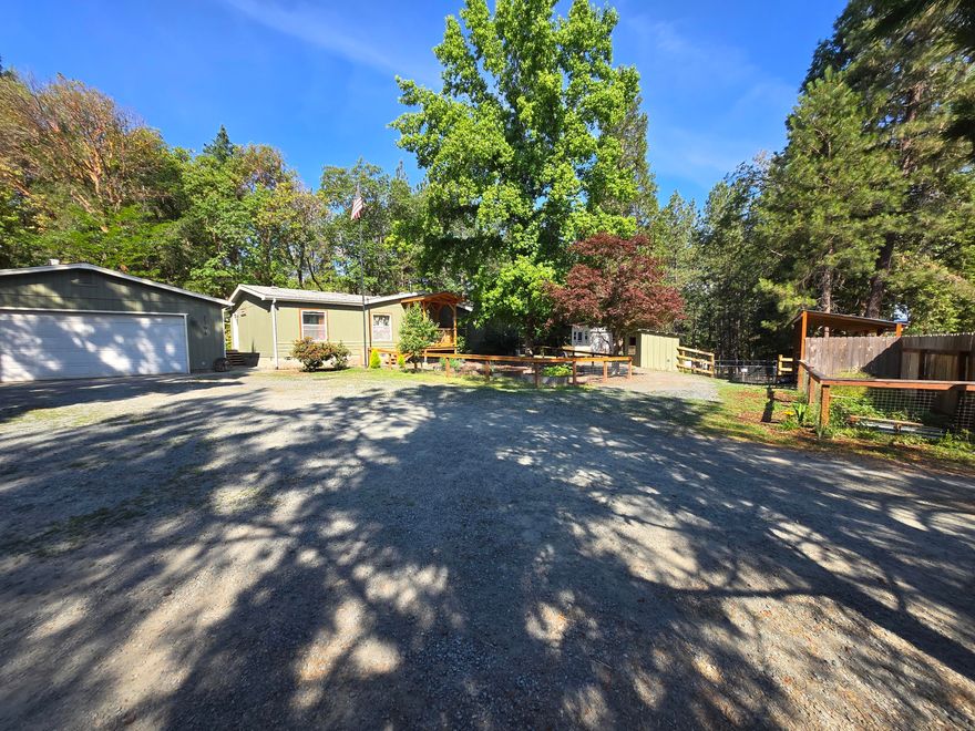This property is bigger than it looks! This fully  fenced property has room for all.  Mini farm if you want it.  Garage, shop, rv parking, storage and more await you with chicken coop areas, garden, water features and a private covered patio makes Oregon living a breeze. Large open living room with laminate flooring, new kitchen remodel and a perfect entertaining property.  Primary bedroom has office off of it or use for storage.  Everything well maintained at this estate. Trails to the back for your quads to carve out your next play area on this property. Close to all outdoor recreation, interstate, shopping and the Rogue River for rafting.   Private entry gate and a welcoming presence will fit all your needs on one property.  Make appt to see this one before it's gone.