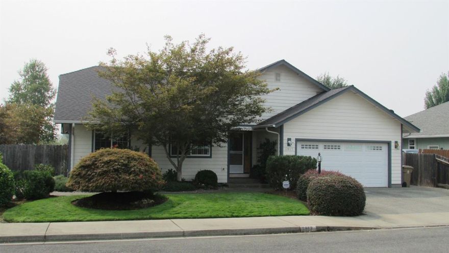 Beautiful Garden Home. The great room looks out on a covered back patio with lovely fountain, blooming plants and shrubs; all low maintenance. The split floor plan includes 3 bedrooms and a den. A bright, open kitchen features beautiful cabinetry, a generous pantry, and an island perfect for entertaining. The spacious master suite includes glass doors to the patio, and a large master bath with walk-in closet. This custom home features gleaming hardwood floors, plant shelves with decorative lighting, lots of storage, a great laundry room, and much more! Quiet, low traffic neighborhood.