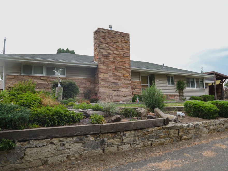 Welcome to this charming single-level 1954 Ranch style home with lots of charming custom built in throughout the home. Large open dining and living room with a beautiful fireplace and windows flooding the home with natural sunlight. Kitchen has all its original 1954 charm with eat in dining. Home sits on .36 of an acre, beautifully landscaped,large covered patio, fruit trees, water rights, tool shed and storage, single car garage and large carport for RV. Quiet neighborhood and so much more.