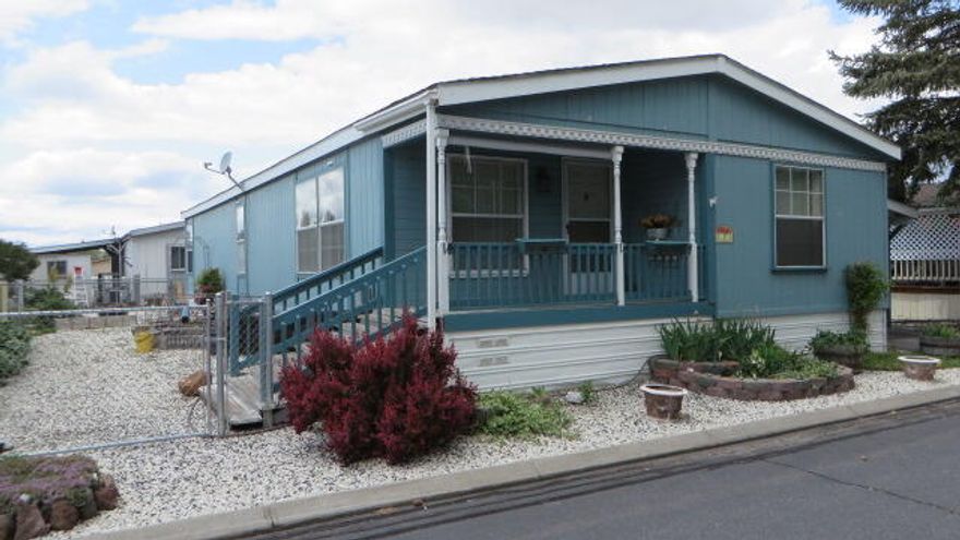 MOVE-IN ready, this manufactured home has spacious rooms throughout.  New HVAC heat pump with central air and new Pergo flooring.  Bedrooms are good-sized, and the primary bedroom has a large walk-in closet and on-suite bath with soaking tub plus separate shower.  Hall bath has an oversized tiled shower. All appliances are included.  Easy maintenance yard with two separate fenced areas. Storage building PLUS additional ''she shed''.  This is a 55+ Park.  Space rent is $426 a month and includes Water, Sewer, Garage.