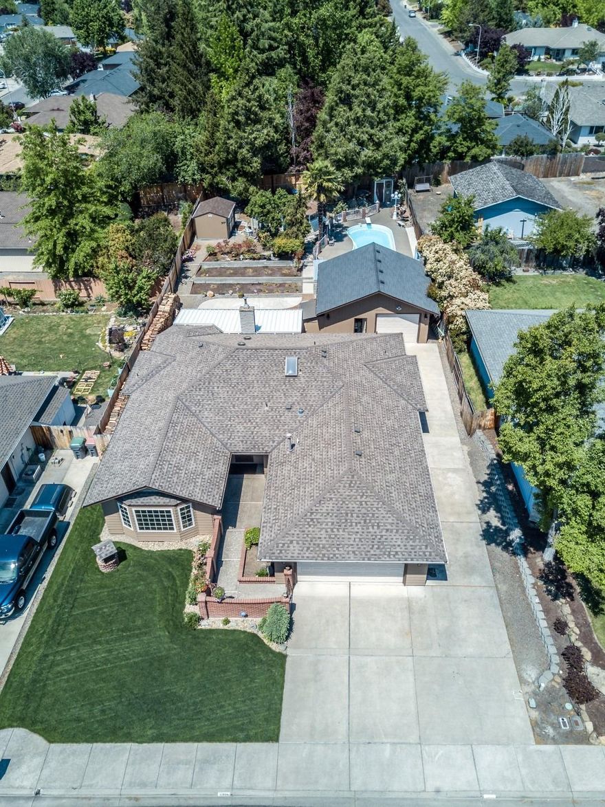 Updated home with custom kitchen and separate living/family rooms, in ground pool, 2 car garage, 24' x 24' shop, 10' x 75' RV parking, large .31 acre lot and more; this E Medford gem is packed with value and hard to find features! The home is located on a quiet dead-end street in the desirable Lone Pine Elementary School District and just minutes to shopping, medical, restaurants and entertainment. It's been updated with a custom kitchen featuring a large island, granite counters, solid wood cabinets, new appliances and refinished hardwoods. The brand new Anderson Windows carry a transferable lifetime warranty, and you'll also enjoy new carpet, interior and exterior paint, certified fireplace insert, new fixtures and toilets plus a newer HVAC and roof. The low maintenance backyard is amazing with a covered patio, pool with 1/2 bath nearby, a Gazebo, built in BBQ, concrete garden beds, new garden shed and new fencing. Pride of ownership inside and out, come tour to appreciate!