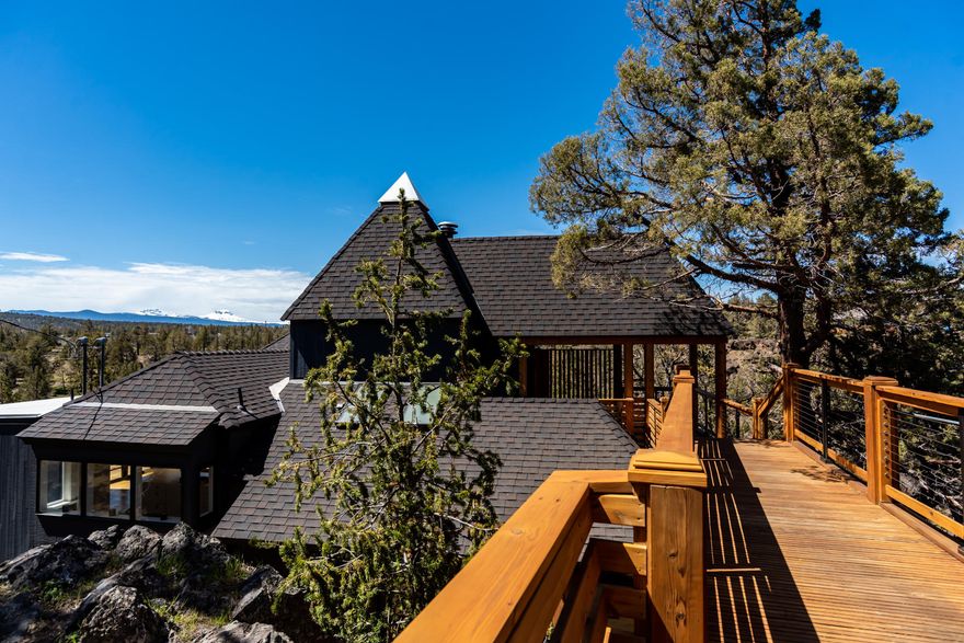 Rare opportunity to own this amazing home overlooking the Deschutes River surrounded by unique rock outcroppings and sweeping Cascade mountain views. Listen to the sounds of the river from almost every room in the home creating a tranquil and peaceful setting  to enjoy. The architectural design of this home, on 1.48 acres, creates a feeling of airy openness at the edge of the world. Private master suite features a custom tile steam shower, walk in master closet and private desk. Kitchen features SS appliances, quartz countertops, large island and ample storage.