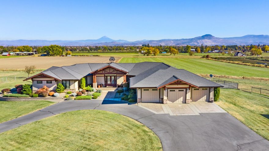 Seven Oaks Ranch is a sprawling masterpiece overlooking 70+/- acres in the Rogue Valley with stunning views of Tablerock Mts and surrounding farmland. Two homes & ability to build 3rd! The elegant main home is full of custom details with open living spaces. Lavish master suite w/ fireplace & private laundry, plus 2 ensuite guest bedrooms, huge office or 4th bedroom, displaying quality craftsmanship throughout. Generous windows overlook patio with in-ground pool & the property's irrigated pastures. This very private estate, with finished 3-car garage, paved circle drive, and security gated entry is situated in the Rogue Valley AVA with strong potential for a well located vineyard site & wine tasting room. The second parcel has historic farmhouse to use as rental, caretaker, tasting rm, etc. This estate offers many possibilities for farming or as a multi-family estate. District irrigation for 62.6 ac, fenced for livestock, & ideally located near airport, restaurants & shopping!