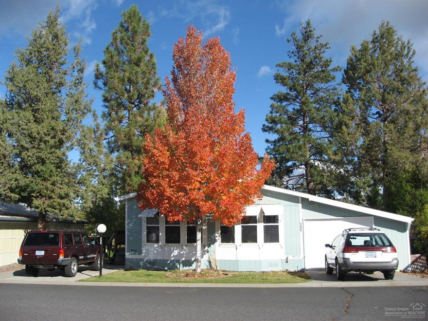 55+ park. One of the larger lots In Suntreee Village backing up to the park. Large garage/shop with additional parking. Lots of windows with individual awnings. Mountain view. Newer roof, paint, 50 gallon hot water heater, heat pump and thermostat. Large utility room with sink. Mountain view outside master also. Vaulted ceiling with fan. Lovely back yard with patio overlooking park with peach and plum trees. Very light and bright. Doggie doors too. Monthly space rent $492 includes water, garbage, sewer, removal of yard debris & snow and use of clubhouse. Close to senior center and Larkspur park with walking trails. Owner occupy only. No sublease.