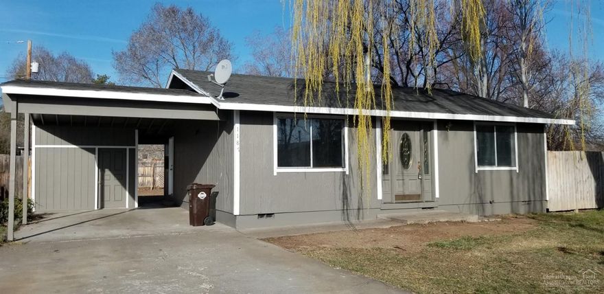Location, Location, Location. NW Redmond adjoining Stack Park and one block from NW Canyon Drive. This charming Redmond home has a lot to offer. Large trees for privacy, .15 acre fenced lot with access off alley. 2 bedroom, 1 bath with 960 sq ft. Nice kitchen with solid surface counter tops and laminate flooring opens to the roomy living area that is carpeted. Attached carport with additional storage area.