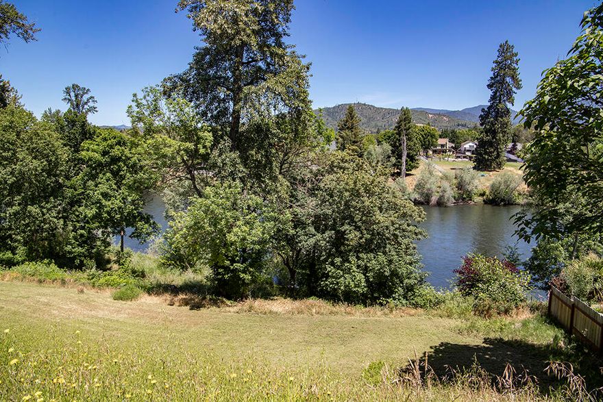 Pretty Rogue River View Lot at the end of a quiet Dead-End Street in a Private Community. Riverfront for all practical purposes, with only the Attractive 'Common Area' of this Exclusive Subdivision running between the Parcel and River. Conveniently located just minutes to Downtown and in an Area of Fine Homes, this is one of only two remaining undeveloped Lots on the River Portion of this Community of Homes. The Common Area is accessed via a well-built Concrete Stairway, and opens onto a wide-open expanse of Rogue River-Front Property for your Recreational Enjoyment. Recently Surveyed, and Utilities are on-site and/or in the Street. The Current Owner will include a Set of Concept Plans and Drawings from a Local Custom Builder for a Home to be built on this Parcel.  Enjoy Lovely River and Mountain Views from this Builder-Ready Parcel!