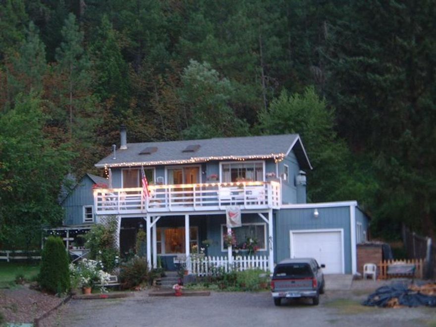 Quaint 3 bedroom, 3 bath home on the opposite side of Hwy 99 on the Rogue River. Two-story cottage-style home has master bedroom on the main floor, two bedrooms each with their own full bath upstairs with a living area and huge deck overlooking the River, to enjoy a leisurely breakfast. Gorgeous landscaping includes a koi fishpond, myriad plantings, waterfall in back. GPID for irrigation. Additional 2-story building includes a plant shed, tool shed, workshop and/or potential guest room (not presently permitted as guest room) or craft room.