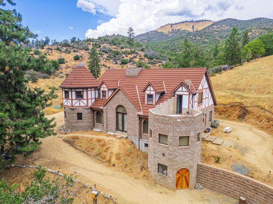 Castle on the Hill - Room to Grow, Space to Dream!
Set atop a knoll with stunning mountain and farm views, this concrete-and-steel home offers lasting quality and comfort. Features include multi-zone hydronic heating (heated floors in some areas), a woodstove with whole-house venting, and a full daylight basement for storage or workspace. Located across the street from the river. The level backyard offers space for a garage, garden, or pool. With 79+ rolling acres, water rights, and direct access to BLM land, there's endless space to roam, ride, or explore. Ideal for animals or projects, the property includes a 1,296 sq.ft. feeder barn with lower-level storage and a 1,600 sq.ft. shop with two bays. Whether you're dreaming of a homestead, farm, B&B, or quiet retreat, this property offers it all.