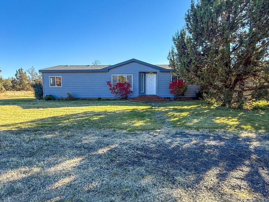 Beautifully updated home on acreage in Prineville, Oregon! This 3-bedroom, 2-bath home sits on 5 acres in the heart of Central Oregon, offering both space and comfort. Enjoy all-new laminate flooring, fresh interior & exterior paint, and a split floor plan for added privacy. The open layout includes a spacious laundry/mudroom with access to a large back deck, perfect for outdoor living.
Outside, you'll find a huge 1,728 sq. ft. shop with four 12' roll-up doors, concrete floors, power, air compressor and plenty of space for your RV, equipment, or hobbies. Additional features include a storage building, plenty of room for your animals or gardening and a circle drive for easy trailer access.