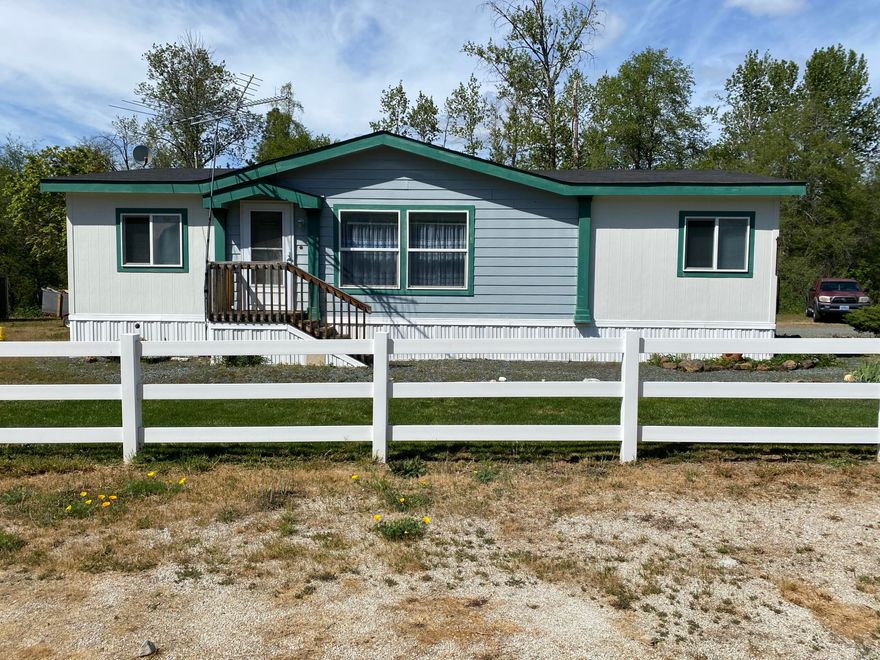 Beautifully maintained manufactured home on huge space in a manufactured home park 
 with manicured lawn, strawberry garden and a creek flowing by.  Split floorplan with spacious master on one side and two more bedrooms and a bathroom on the other. Open kitchen/living room area with front deck and side deck leading into the laundry room. Space rent is $700/month and includes water/sewer. There is also space for a small RV and a nice little storage shed too!