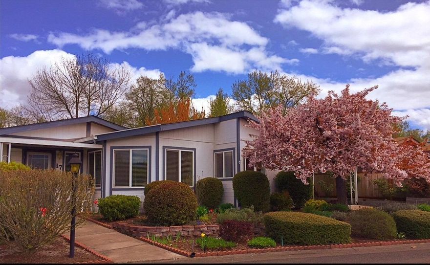 Beautifully maintained triple wide manufactured home in one of the most desirable parks in Jackson County, Mountain View Estates. Light and bright with great open floor plan, cathedral ceilings, skylights in the kitchen, master bath and laundry room. Two bedrooms plus an office with many upgrades including kitchen cabinets and the bathroom. The unit backs to the creek for privacy and has raised beds in the backyard for flowers and herbs and a rose bed along one side of the front yard. Manicured landscaping with sprinkler system. Roof was put on in 2001 and new heat pump in 2004. In addition to the nice clubhouse, the pool at Mountain View Estates is being resurfaced before it opens in the spring. It is a great place to relax and chat with friends. (more pictures to come)