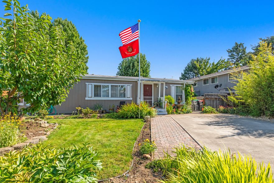 With an inviting, beautifully landscaped front yard with flower and fruit trees, you will feel at home the moment you arrive. In the backyard you will find a lovely garden area with strawberries and blackberries and plenty of space to relax. This affordable, 3 bedroom, 2 full bath 1188 sq.ft home offers a split floor plan, vaulted ceilings and open concept. Recent updates to both bathrooms, new water heater in 2019, new sprinkler system in backyard. Large shed with bonus room that would make a great hobby room or shop. Room for RV parking. Close to amenities. Great home for first time home buyers or those looking to downsize. Price at just $215,000.