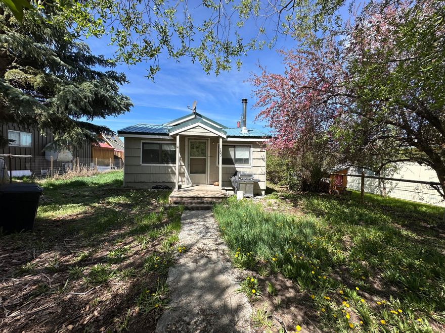 Charming bungalow situated on a 0.11-acre lot, featuring three bedrooms and one bathroom within a comfortable 986 square feet. The kitchen is equipped with an electric range, refrigerator, and a traditional wood cookstove. The home also boasts a modern Blazeking woodstove, only a few years old. The property includes a fenced yard, a storage shed/workroom, and a woodshed, complemented by a durable metal roof. Located in Seneca, this property serves as a gateway to thousands of acres of public land, making it an ideal retreat for outdoor enthusiasts or a wonderful place to reside year-round.  Possible owner carry with acceptable down payment and terms.