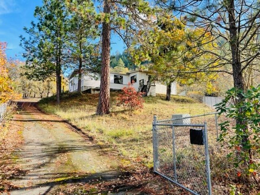 Secluded 5 acres with manufactured double wide on foundation with well and septic. Only 14 minutes south of town. Bordering 247 acres of BLM with seasonal pond and detached 2 car garage. Finish the restoration on this Manufactured home to your dreams. Fenced, gated and paved.