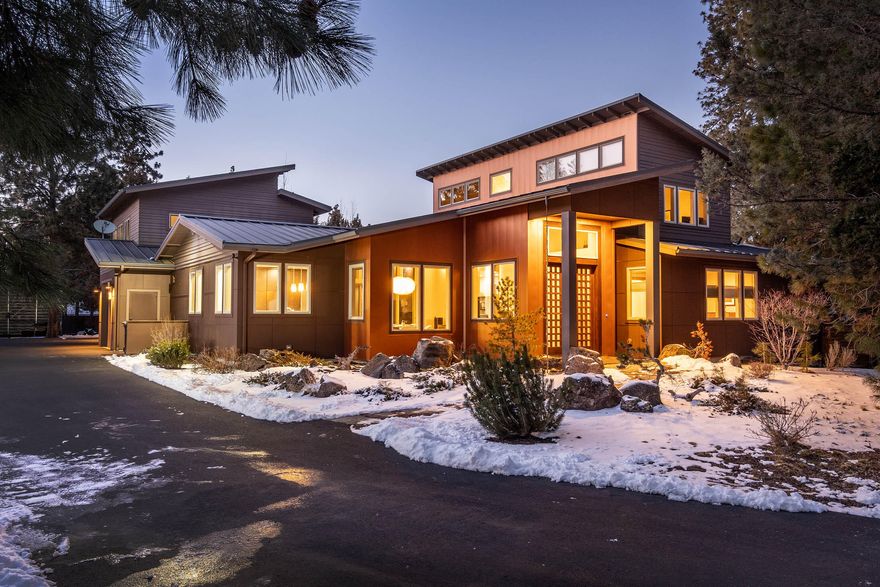 A stunning contempory-style residence located in walking distance to the Old Mill and the Deschutes river trail. Situated on roughly half an acre in the peaceful and sought after Woodriver Village community, this custom built home comes equipped with numerous luxurious amenities and is the ideal home for those looking to be in the heart of all that Bend has to offer! 
Entering the 2,985 sq ft main house you're greeted with high ceilings and a welcoming living room. There are two primary bedrooms on the main level, and an additional bedroom plus bonus room/office on the second level. The primary rooms are thoughtfully designed to be as spacious as possible, each with walk-in closets and resort-style amenities including a soaking tub and steam shower. The kitchen contains custom built cabinets, quartz countertops, and stainless steel appliances. Separate is a fully equipped 600 sq ft ADU above the 3-car heated garage and an additional covered 30x40 RV storage with electrical hookups.