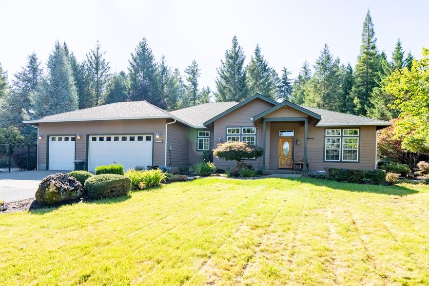 Welcome to your Oregon dream home! This beautiful custom home is set on 5 picturesque acres and has been very well maintained. Built in 2001, it offers a spacious open floor plan with 2,007 sq ft, featuring 3 bedrooms and 2 baths. You'll love the charming details like arches, beautiful and bright windows, 10-ft ceilings, a cozy fireplace, and a sunroom that brings in the light! The kitchen is perfect for cooking and entertaining, complete with a breakfast bar and granite countertops. The primary suite opens to a covered patio and hot tub, with a relaxing ensuite bath featuring a soaking tub and walk-in closet. Step outside to enjoy the gorgeous grounds, which include a concrete patio, water feature, gazebo, rose garden, and even a putting green! There's also a 3-car attached garage (one bay can be a craft room) and a detached heated shop (30 x 36) for all your hobbies. With a gated entry, fully fenced and paved driveway, this home and property truly has it all.