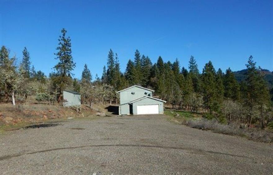 Two-story 4 bedroom, 2 bath home on over 5 scenic acres in Trail. Outside is a covered front porch perfect for entertaining or just enjoying the view. Inside, home has a large kitchen with lots of cabinet space and built-in island/bar area, laundry room just off kitchen for ease of use, and LOTS of natural light. Attached garage and shed to cover all your storage needs, and if that's not enough, secondary detached shed gives you even MORE space. HURRY, this one won't last long!