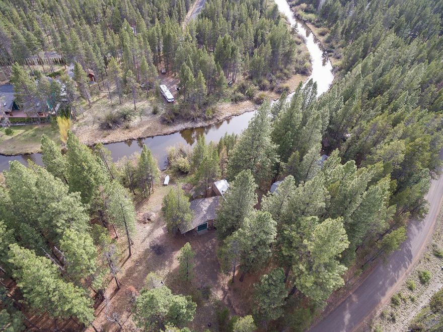 Beautiful treed setting on the canal with direct access to the Deschutes River! Property includes stick built bonus room, attached garage plus carport with an attached manufactured home featuring a great room, kitchen, dining area, 2 bedrooms and 1 full bath. Updates include new roof in 7/2011, new furnace 12/2017, vinyl windows installed in manufactured home. Community park, clubhouse & boat launch. Septic with fiberglass tank inspected & pumped 4/2018 with DEQ Report. Well water analysis completed 5/2018.