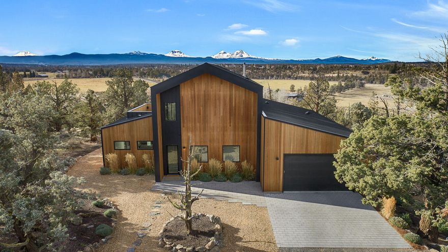 A rare legacy with sweeping Cascade Mountain and Deschutes River views, this Scandinavian-inspired retreat blends modern craftsmanship with timeless design. Built in 2021, the residence offers 3 bedrooms and 3.5 baths, curated for privacy and effortless luxury. Custom concrete countertops, Baptista tile accents, and a chef's kitchen appointed with Thermador appliances reflect exceptional attention to detail. A dramatic five-panel folding door system seamlessly connects indoor living to the outdoors, capturing the home's expansive natural surroundings. Set on over four acres of non-irrigated, native landscape, this private sanctuary offers a profound sense of space, serenity, and connection to the land.  The detached 2 bedroom guest house provides for multi-generation living or a private space for guests.