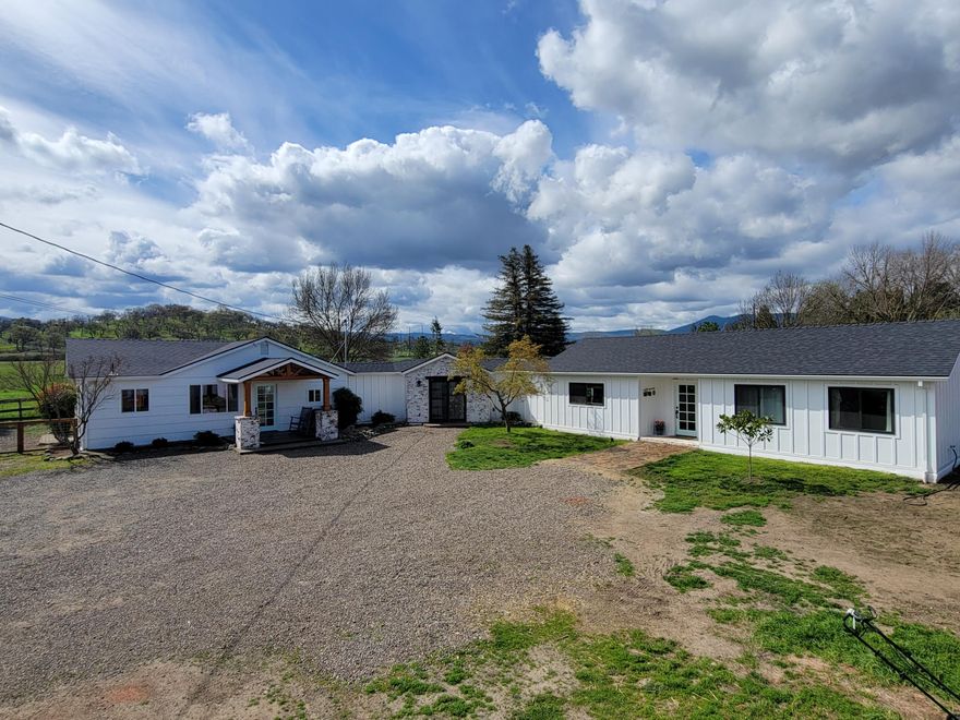 So much opportunity with this property.  Awesome single family property -or- live in one side and rent the other -or- in-law set up -or- vacation rental -or- possibly traveling nurse rental...take a look and decide for yourself! Fantastic farmhouse in a prime Southern Oregon location offers beautiful pastoral and mountain views.  Situated on a large, fully fenced and gated lot, this property is located minutes to Jacksonville and in close proximity to wineries, organic farm stand and much more.  Original home was completely remodeled in 2017 and the new addition was added in 2020.  Property offers tons of parking, a new storage shed, 2 wells (original well with holding tank and a new well that produces 10+gpm), a great patio off the living room and lots of room to play.   Home offers 2 living rooms, 2 dining areas and 2 laundry rooms and offers a beautiful sunroom. This property has so much to offer...Don't miss this one!