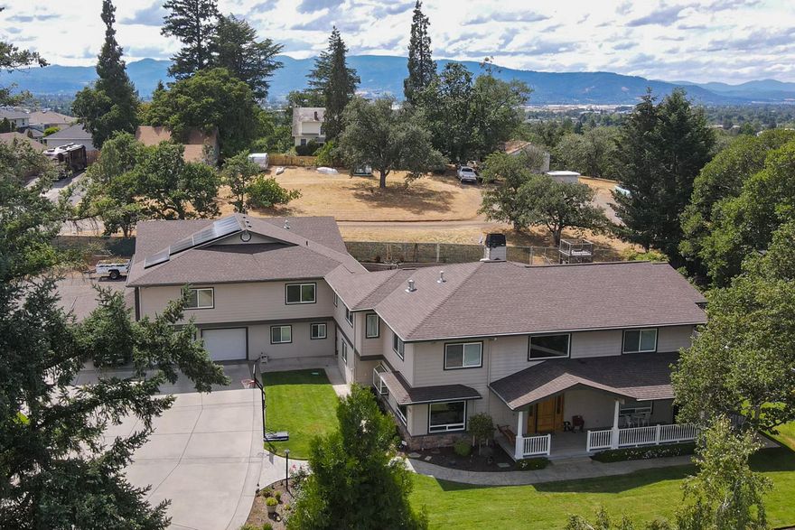 Here it is! A 2 family set-up just minutes from downtown Medford. This is a one of a kind property that has numerous possibilities! With .74 of an acre, property like this does not come along very often.  Main home is 3800 sq. ft. W/ 5 bed 3 full baths.  Second dwelling 1783 sqft  2 bed 1 bath.  Main home master bath has heated floors + it's own private deck. Huge kitchen w/ Stainless Steel Appliances, Dual fuel commercial grade range and built-in fridge. Media room with built in entertainment center and a Bose system throughout home & outside. Fenced backyard with saltwater pool and auto cover.  Huge shop with 12' roll up door, 15' ceiling, + large covered and gated RV/boat parking with RV hookups & a 2 car garage with covered carport and a 14,000W  Solar system.  Centrally located between Providence and Rogue Valley hospitals