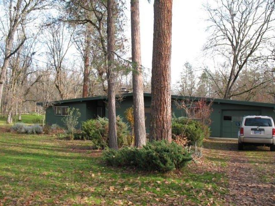 Character, character in this mid century modern home that sits back off the road for privacy. Tongue and grove ceilings throughout the home including the attached breezeway and garage. The garage has one door but when you enter you will find a oversized two car garage with tons of built-in cabinets, work bench and floor to ceiling closets. There are also several outbuildings for additional storage plus a garden shed. Enjoy the great outdoors from the larger windows or concrete patio. The property is flat and beautifully treed. Recent updates all new interior and exterior paint, refinished oak wood floors and kitchen cabinets. Home is move-in ready and will sell itself.