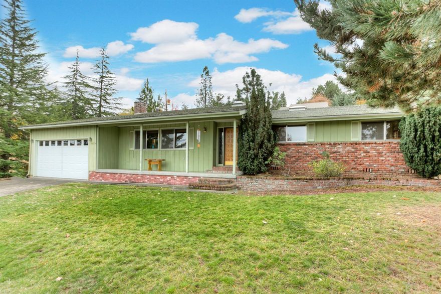 Open spaces and a great layout. Large living area with fireplace and beautiful views of the hills. Kitchen has granite counter tops and opens to formal dining space. Hardwood and tile floors throughout. Skylights for an open bright feel. Many updates. Great location above the University. Bonus room with private bath. Great for additional bedroom, office, or studio.