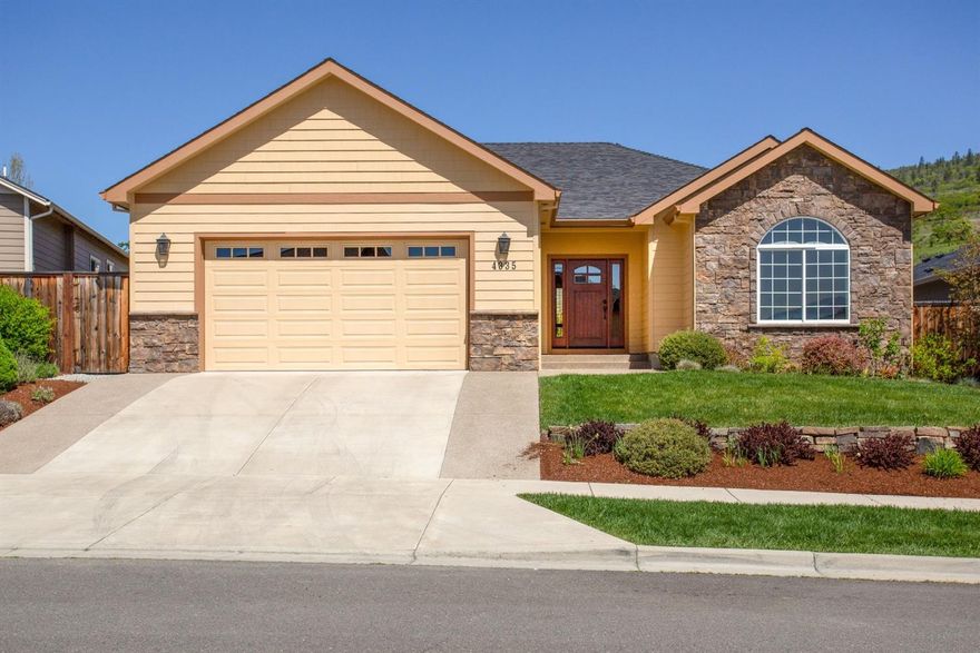 This beautifully kept and well maintained home is in the desirable Vista Pointe neighborhood of East Medford. With fresh exterior paint, this very clean 2124 sq. ft. home has three bedrooms and two bathrooms, and is a Certified Earth Advantage home. The master bedroom has a vaulted ceiling, with an expansive walk-in closet, double sinks, and an extra large soaking tub. The home boasts a large living room with 9ft. vaulted ceilings and a gas fireplace with a custom hearth.The kitchen is large with granite countertops, a chef's 5 burner gas stove, double ovens, and large refrigerator. A granite bar area seats 3 and flows into an extra large dining room. There is also a huge walk-in pantry and separate laundry room. The house has lots of storage throughout. This home sits on a large lot. It has a hot tub under a covered back porch, including views of Roxy Ann. The backyard is fully landscaped and is blooming from March to November. Don't miss out on this one. It will go fast.