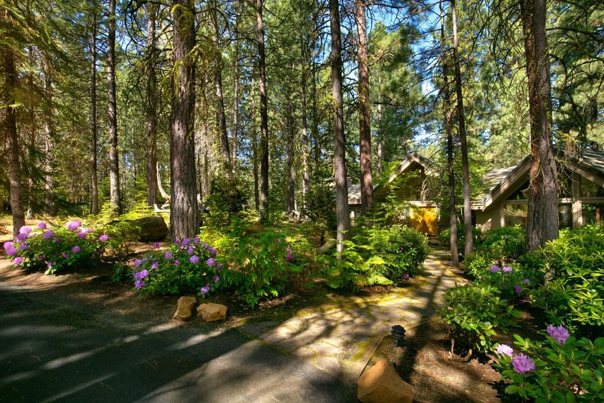 This single level custom home is situated on the Glaze Meadow Golf Course with four spacious bedrooms, including two master suites. With a generous 3,152 sq. ft. of living space and a sprawling 1.14-acre lot with lush gardens and a sweeping lawn, this home offers plenty of room for you and your loved ones to spread out and enjoy. You'll love the wooden plank vaulted ceilings throughout, numerous skylights and three wood burning fireplaces, which create a cozy and inviting atmosphere no matter the season. The chef's kitchen is a true highlight, with ample counter space and top-of-the-line appliances. Step outside onto the large deck and take in the breathtaking views. Nestled on a private cul-de-sac, the home is a stone's throw from the Upper Glaze Meadow Pool/Tennis Complex. This setting is perfect for entertaining guests or simply relaxing with a cup of coffee. You have your choice of watching golf, or enjoying looking out on the peaceful, undisturbed wooded grounds.