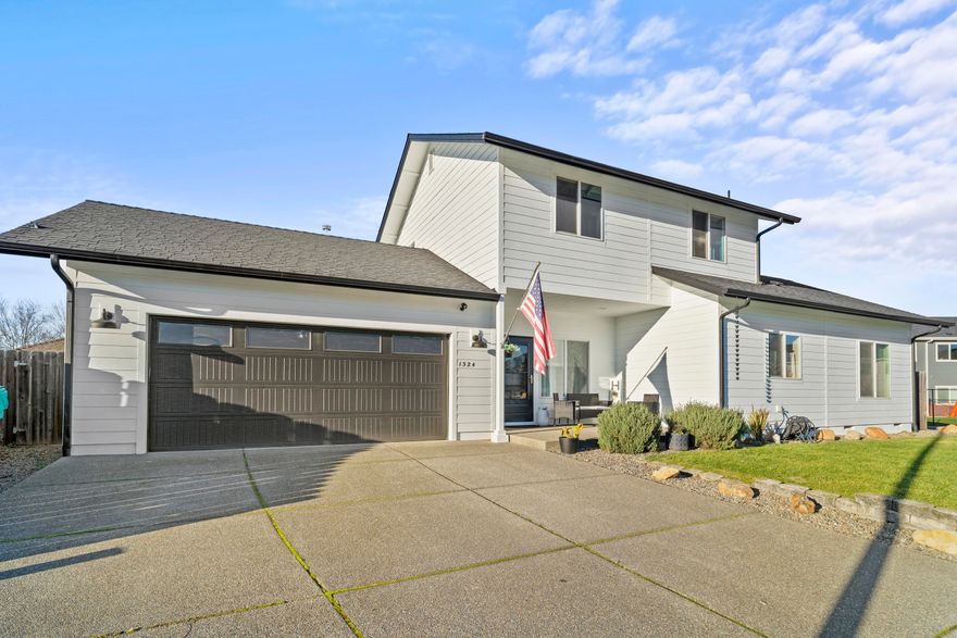 Nestled in a quiet Grants Pass cul-de-sac, this home has everything you need! Boasting 1,533 Sq Ft, vaulted ceilings, and tons of natural light, this home is spacious and comfortable. Freshly painted in 2021 and new flooring in 2021 make this home turn-key. The kitchen is fully equipped with a breakfast bar, lots of storage, and appliances from 2021 and newer. Lighting is all updated with dimmer switches. The primary bedroom, located on the main floor, is bright and generously sized with a large closet and ensuite bathroom. Two bedrooms upstairs are perfect for a growing family, office space, or guests and offer privacy for the master suite downstairs. Outside, you will find a low maintenance (w/plenty of room for kids/pets) and clean backyard with a garden bed, a front and back sprinkler system with a control box. And if you're in need of extra space, the garage contains large overhead storage. Don't miss your chance to call this lovely house your home, schedule a tour today!