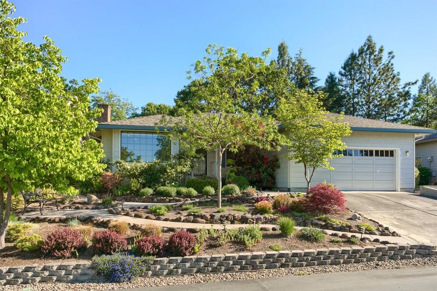 Be a part of the highly sought after Sun Oaks Community in this beautiful home generously remodeled since 2011. Built in 1986, appointed with 3 bedrooms, 2 baths, this open concept floor plan offers hand-scraped hardwood floors throughout the main living area to include the living and family room, kitchen and sunroom. Enjoy your living room with a wood fireplace with brick surround and large picture window. This open concept has great flow into the open dining and family room detail with vaulted ceilings and generous spaces. Enjoy cooking and entertaining in the updated kitchen with a 5 burner gas range/oven, refinished cabinetry, granite counter tops and large island with butcher block countertop connected to a quaint breakfast nook with a pass thru windows to the back patio and views of the lovely grounds. The outdoor space has been thoughtfully manicured into your own personal sactuary with low maintenance plantings and a smart subterranean irrigation system.
