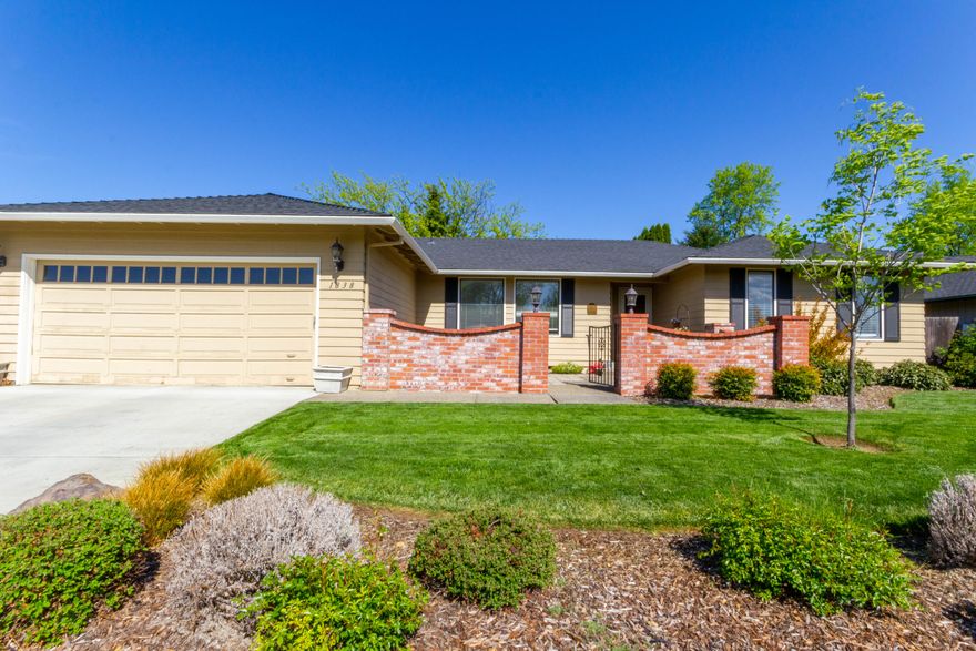 Charming East Medford in a highly desirable neighborhood.  Located close to Lone Pine Elementary and North Medford High School.  Great curb appeal with a small courtyard at the entrance with plenty of room for a sitting area. Spacious home with two large living spaces and formal dining room.  Plenty of natural light in the front living room that has large picture windows with views of the courtyard.  The kitchen opens to the family room that has a fireplace and views of the beautiful backyard.  The kitchen has granite counters and breakfast nook.  The owners have put in all new laminate wood flooring throughout.  The guest bath has been updated with 2 above counter sinks and tile flooring and new fixtures and mirrors.  The primary suite has walk in closet and a dual vanity full bath.  The additional bedrooms are good sized.  The backyard has been completely redone and is ideal for entertaining with a covered patio and large grass area.  It is a must see!