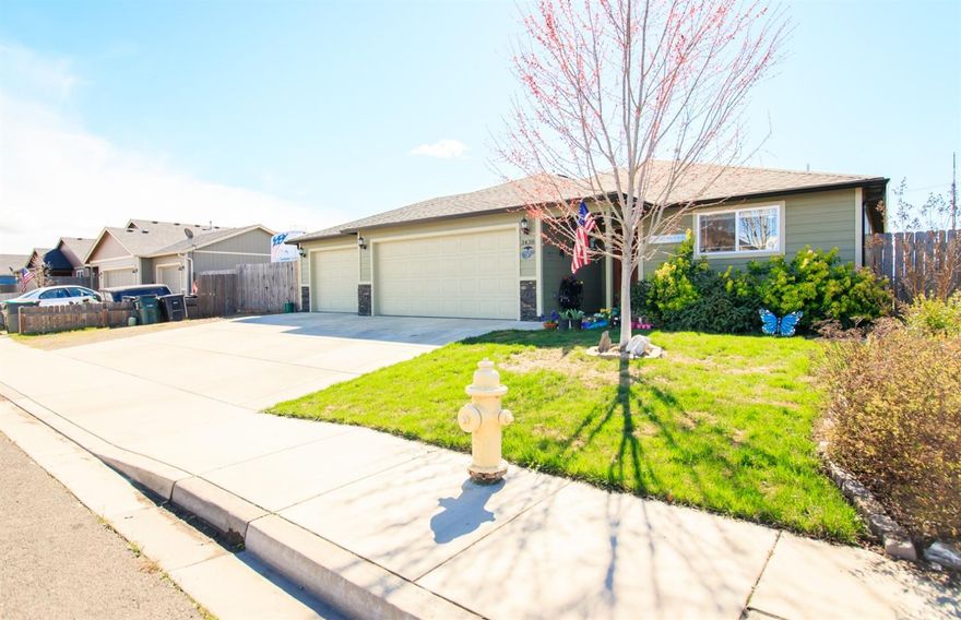 Really Nice, well kept 1608 sq. ft. open floor plan home built in 2013. The home features 3 bedrooms and 2 full bathrooms. The large living room has vaulted ceilings, beautiful laminate flooring and plenty of windows for light. The kitchen is adorned with rich wood shaker style cabinets, granite counter tops with chiseled edges and stainless steel appliances. The spacious master bedroom has a vaulted ceiling, walk in closet and a sweet master bathroom with Granite counter top. Additionally the home has an indoor laundry room and a THREE car separated finished garage, so there is plenty of room for vehicles and storage or a shop area. Outside is a nice fenced yard with sprinkler system, a patio for outdoor enjoyment plus a large RV parking area.