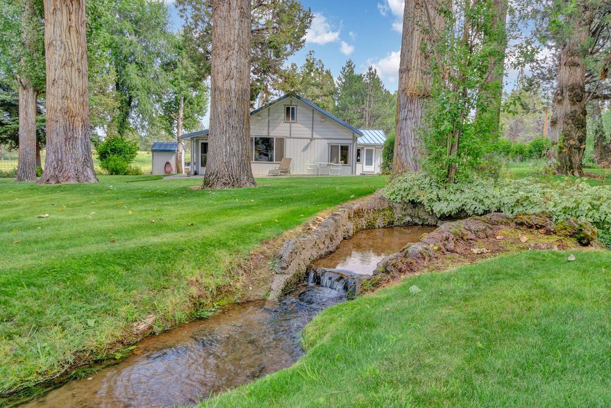 A rare, beautiful and private ranch retreat just minutes from Bend!  This secluded paradise offers 120 acres of irrigated rolling pastures with 76 acres of irrigation rights and ponds. This is an excellent opportunity for your horse or livestock operation. The timeless, single level ranch style home offers an open floor plan, timber beams, 1,500 +/- sq.ft. basement and large picture windows to take in the peaceful landscape; manicured yard, mature trees and a meandering irrigation canal.  Infrastructure in place includes; barn, animal stalls, arena, corral, workshop, greenhouse and fenced garden and in-law quarters. This serene setting offers a buffer of public land which borders this property for exceptional riding and hiking. Recent upgrades to the cattle handling facility with pipe fencing and nice layout to sort and process with ease. Property is fenced and cross fenced plus new stock troughs throughout the pastures. Productive ground for haying or pasturing your livestock.
