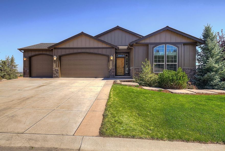 Gorgeous views of Smith Rock and the city from this Northwest Contemporary! Great room plan with tile entry, vaulted ceilings and gas fireplace with stone accents. Kitchen with granite counters, island with breakfast bar, built-in desk, hardwoods and gas appliances. Loaded with upgrades and luxury finishes throughout. Large utility room with lots of cabinetry for storage. Huge extra storage room in basement and triple car garage.