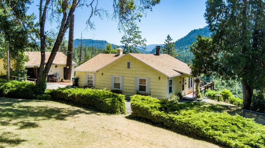 Nice Rural Property Setting.  This 1312 sq ft solid built home with living room; open galley kitchen with lots of countertop space; 3 bedrooms & 1 full bath; laundry room. New HVAC system. There is a detached shop/garage, plus 3 bay metal storage building: fenced garden area.  The home is on 6.37 acres and has amazing views of the Rogue River!