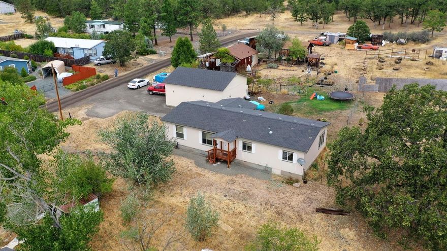 Well maintained 2006 MFH with 3 bedrooms, 2 bath home on .29 ac with 1512 SF, Large finished detached garage/shop. Lots of room to work and play with ample storage. Home has a great well and on city sewer. Just down the road from the Rogue River for great fishing, rafting and camping.