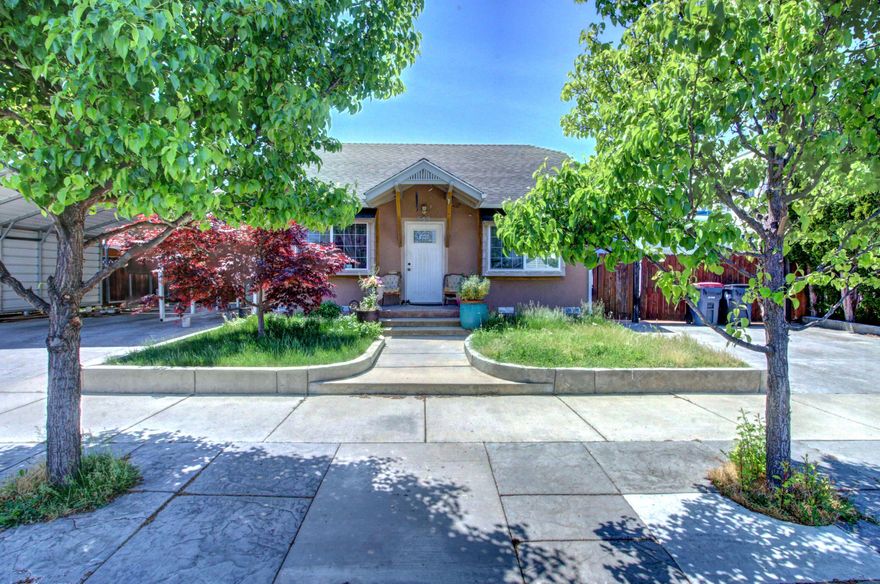 Introducing an exceptional investment opportunity with flexible living options. This property features a charming two-bedroom, one-bathroom house at the front, along with a detached shop which could be set up for 2 family set-up or rental income (buyers to do their own due diligence regarding use). The seller has completed some upgrades on the property. Outside, you'll find a large RV gate leading to a huge, cemented RV area with full hookups. The left side offers an oversized stamped concrete driveway, providing ample parking space. An outdoor laundry room conveniently serves the main house and the additional unit in the back. The home is situated near town, schools, and shopping (perfect for convenience and accessibility). Inside, you'll appreciate the tile flooring, including the bathroom shower. Stay comfortable with the natural gas wall heater and enjoy the ambiance of a brick-surrounded wood-burning fireplace. Priced to sell.