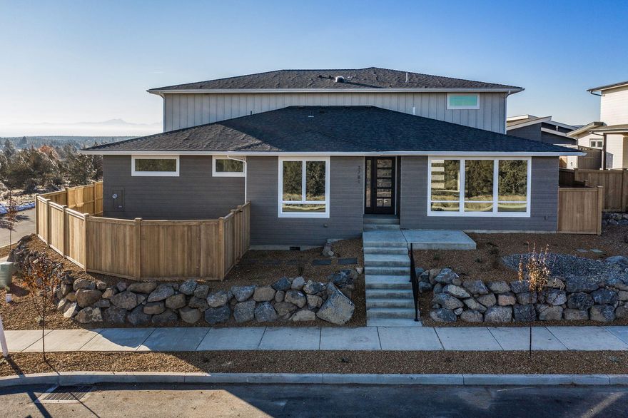 Talmage Construction at its finest. The reverse living floor plan offers 4 total bedrooms, 3 being suites with private bathrooms. Downstairs  you will find 2 bedrooms, office, 2 full bathrooms, living space/bonus area and laundry closet. The main living spaces are upstairs to take advantage of the outstanding Cascade Mountain views. Natural stone countertops and backsplash are the feature accent in the open kitchen with plenty of storage and stainless steel Bosch appliances. Beyond the kitchen and into the main living space the Cascade Mountain views shine brightly through the large windows offering tons of natural light. A large double sided fireplace separates the living room from the dining and through the sliding door to the massive second story deck. The large master bedroom and bath have private access to the deck as well. And do not forget about the nearly 1600sf garage and additional covered parking.