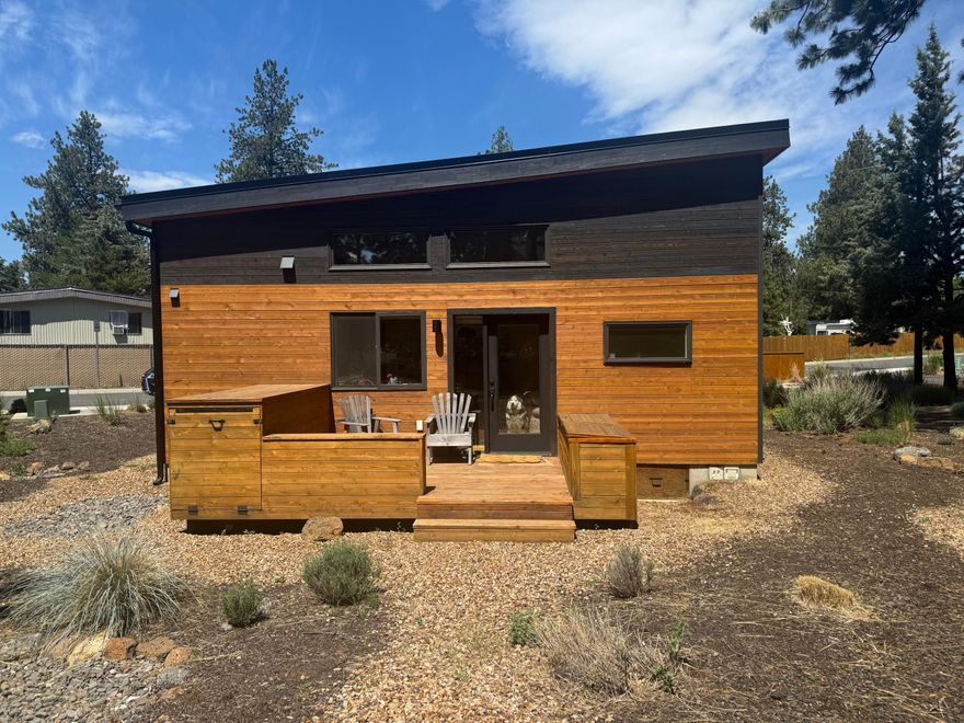 he Hiatus - Bend's premier cottage community! Unit 11 offers a opportunity to own a stylish, 598 sq ft modern cottage nestled on a private lot in a park-like setting. Designed for simplicity, efficiency, this home blends intentional design w/luxurious finishes - all while maintaining affordability. Step inside to discover a light-filled, open layout w/wood floors, a sleek modern kitchen, smart built-in storage, & a lofted bedroom with steel railing that maximizes space & style. A full bath & in-unit laundry offer effortless living. An additional loft for guest above bathroom. Outside, your own back deck w/2 storage boxes, overlooking the community garden. The Hiatus community is rich w/charm: meandering paver paths, tranquil ponds, lush gardens, mature pines, cozy fire pits, a gathering space for live music & neighborly hangs. Live minimally, comfortably, & beautifully w/ high-efficiency systems & eco-conscious construction that support modern, sustainable living.