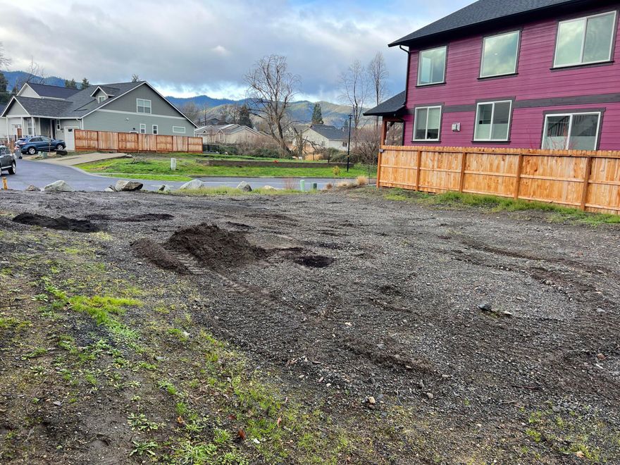 One of the very last buildable lots in the Old Bridge Village subdivision after the Almeda fire. Bring plans for your dream home or your investment property to this fantastic location near to downtown Talent! Featuring a level .10 acre lot tucked back in a quiet location off Talent Avenue and near the open space. Per City of Talent: The site has water meter and System Development Charge credits that can be applied to the building permit. This credit expires when the City of Talent Emergency Order is lifted prior to or on September 1, 2025. The zoning for the site is Residential High Density (RHD), allowing for a main home and an ADU, provided they meet the setback requirements of the RHD zone. Buyer to do their own due diligence on allowed uses and permits with the City of Talent.