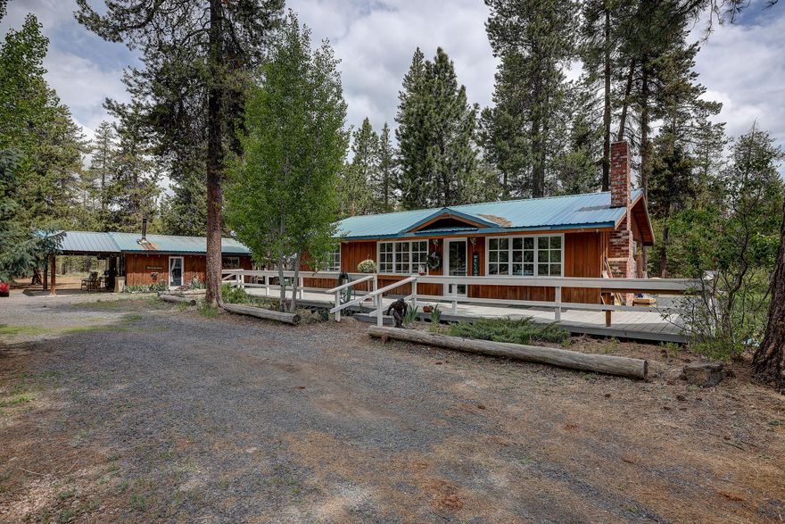 Enjoy this peaceful 1.82 acres surrounded by trees and sounds of nature. The cozy setting is minutes from town yet has room to breathe, away from the hustle and bustle of city life. This spacious property has an ADU, garage/shop, greenhouse, horse corral, a circular driveway and RV hookups. Beautiful rustic wood throughout the home gives a cabin feeling, with all the comforts of home. Choose your spot on the large deck that looks out across the property from three sides of the home. Don't miss out on the getaway in the woods.