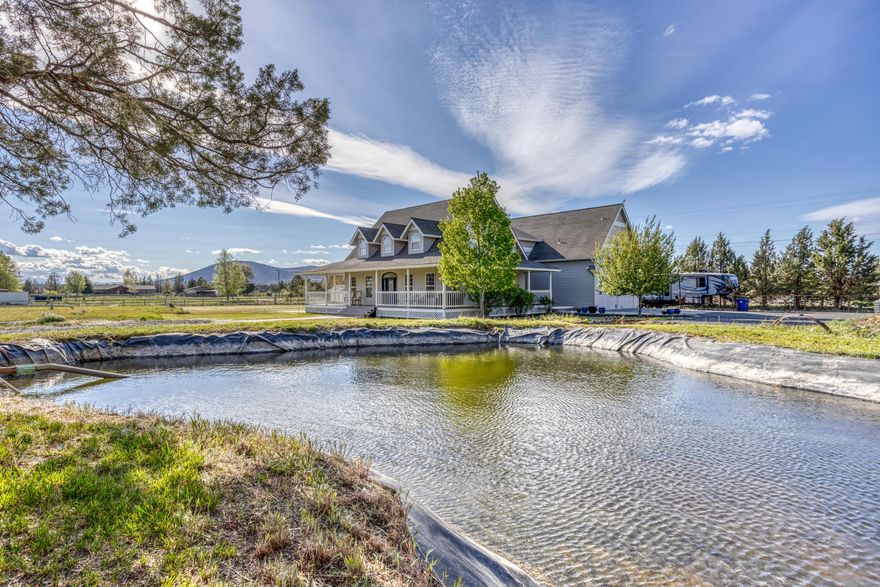 Incredible Country living on acreage. Watch the amazing Cascade Views from the newly installed deck and wrap around porch. This large updated home has it all; new kitchen with granite counters, double oven, and a large pantry with a utility sink. The open floor plan has a great room, dining area, living room, bonus room, laundry room, 5 bedrooms including 2 master suites, 3 full bathrooms and 2 half baths. Family room has a Tulikivi fireplace/stove that can be used for heat or cooking.  Lot is 4.32 acres with 3.32 acres of irrigation with a pond and large enclosed car port.  This wonderful home is perfect for entertaining and living a Central Oregon lifestyle.