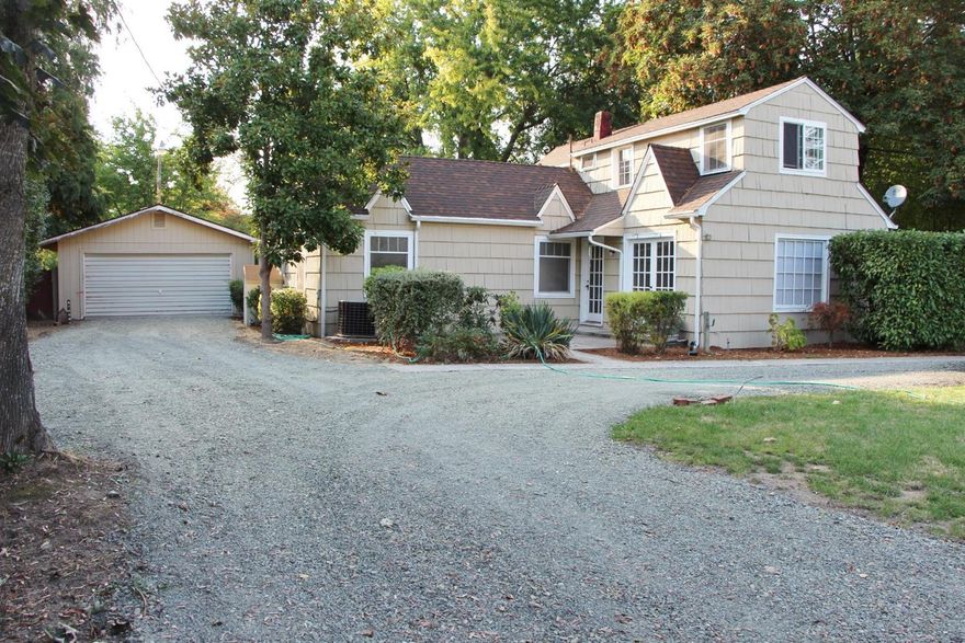 Hard to find a home on a .41 acre lot with over 2170sf of living area in this price range and located in the Grants Pass District 7 school district. The open style floor plan has a lot of character in the details, the built ins, and the fireplace. The master and second bedrooms are located on the main floor. There is a partial basement, central a/c & heat, country kitchen, laundry room, and a spot for that wood stove. The detached 2 car garage is finished and has a pull-through garage that opens up a bundle of options and provides easy access to the back yard. The residence is set towards the back of the property and has a circular drive, mature landscaping and outbuildings. Zoned R-2 so there is potential development, buyer and buyer's agent to perform their own their due-diligence. This 2 story home has a lot of charm and it will make its next owner a great home.