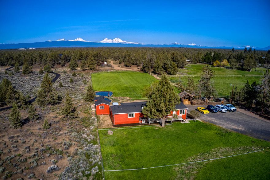 Beautiful mountain views from this 5 acre parcel strategically located on Deschutes market road halfway between Bend and Redmond.  Acreage is set up for horses with a loafing shed and round pen.  The property comes with two acres of COI irrigation that is delivered from two picture perfect elevated ponds.  Irrigation piping is included which makes watering easy on this parcel.  The manufactured home is in excellent condition having a new roof and new paint on the exterior.   Woodstove is new to keep you warm and a split for cooling in the summer and additional heat in the winter.  There are outbuildings for storage and livestock as well.  Power sources are well located on the property.  Call Mark to arrange a showing today.