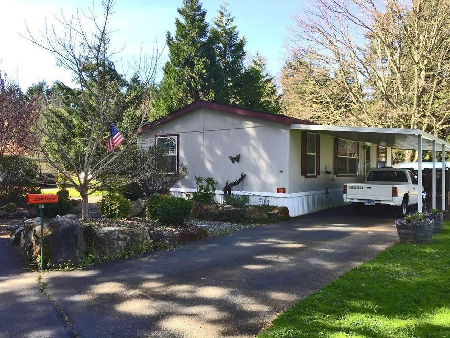 This immaculate home sits at the end of the quiet River Valley MH Park among tall trees where you feel in the middle of the Country. Well designed open floor plan with lots of windows to let the country feeling in. Covered front and back porches, low maintenance landscape with large rocks and drip irrigation, interior shutters on all windows, fenced back yard, vaulted ceilings, crown molding, large master bathroom with walk-in closet, all kitchen appliances stay.The space next to this home is vacant and a common area, giving this home a perfect location to call Home.