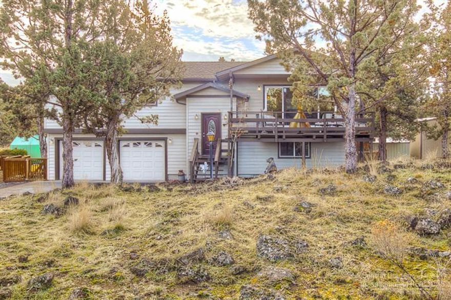 Tucked in a private community & surrounded by natural landscape, you'll call this property home. Move in ready w/great room feel, wall to wall glass brings the outside in. Open kitchen w/tiled ctrs, bar seating & built in wine rack. Living & dining open to expansive decks. Master on main level w/tiled shwr. Bonus room & 4th br/den down. New HVAC in 2014. RV garage & shop, 220 power & water, concrete floor w/work room already built in! Coop, greenhouse and outbuildings w/water & power. Horse friendly area!