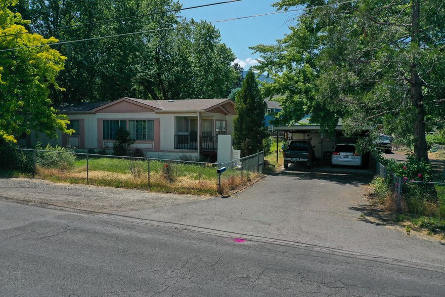 Come tour this property with mountain views, minutes away from many of Ashlands amenities and close to downtown. It is a 2/2 manufactured home with an office that sits on an its own generous size lot. It also has a detached garage with plenty of space for multiple cars and have a workshop area or turn it into whatever you desire. There is also a storage area attached to it.